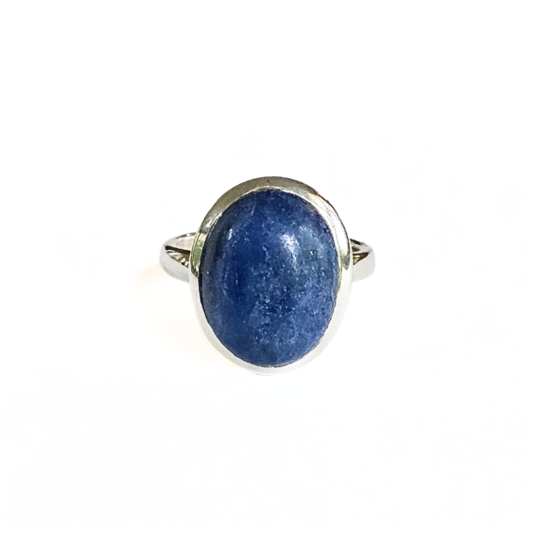 Ring with a blue stone and silver band on a white background