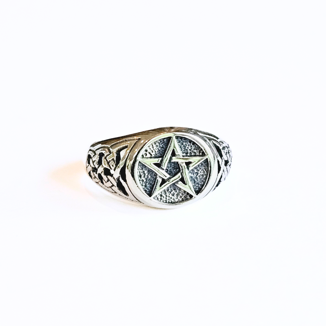 A silver ring featuring a Celtic pentacle design at the center with intricate patterns on the band.