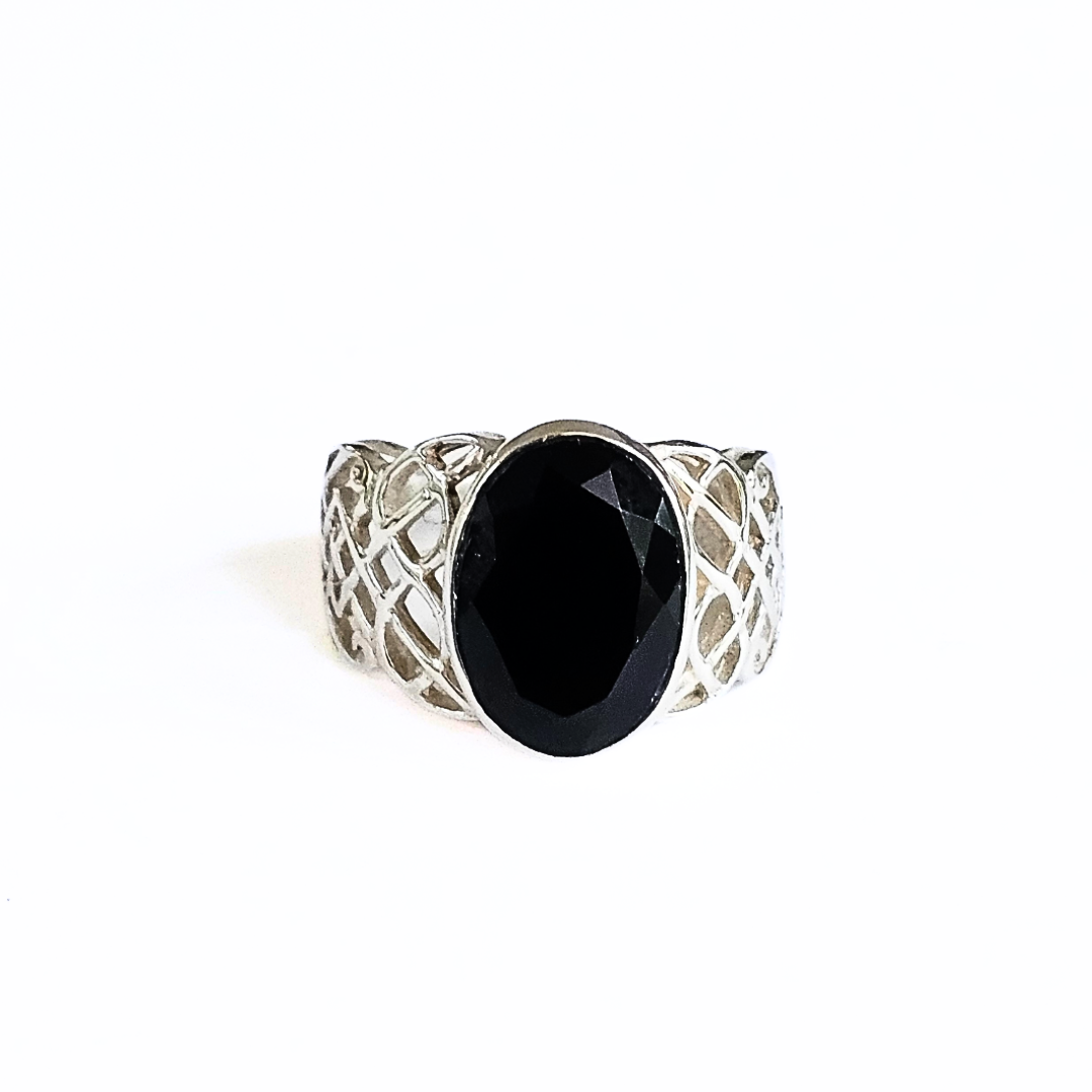 A sterling silver Celtic ring with a large black onyx gemstone in the center, featuring intricate knotwork on a white background.