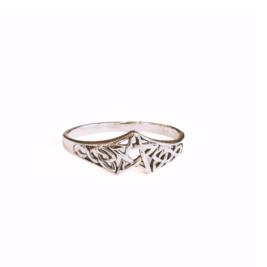 Silver ring with intricate design on a white background