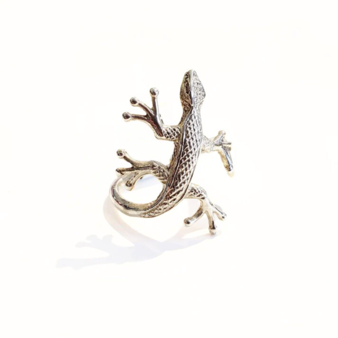 A sterling silver ring with a detailed geometric design resembling a gecko.